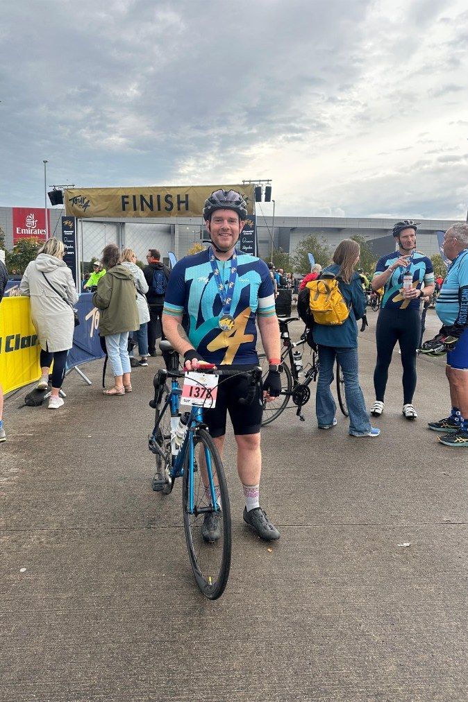 Jonny with his bike at the finish line